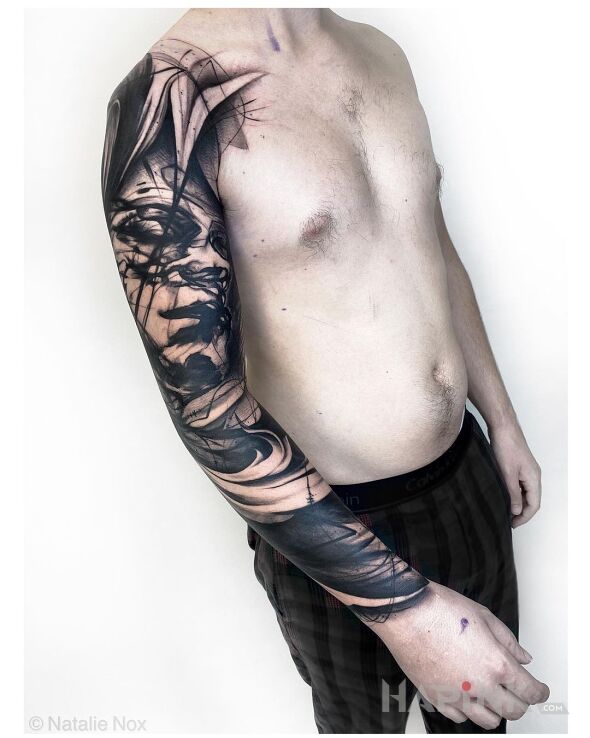 Tattoo Pomazana twarz in faces motif and realistic style On the arm