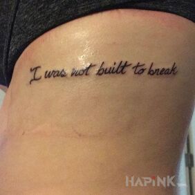 Tattoo I was not made to destroy me on the ribs motif: lettering style: calligraphy