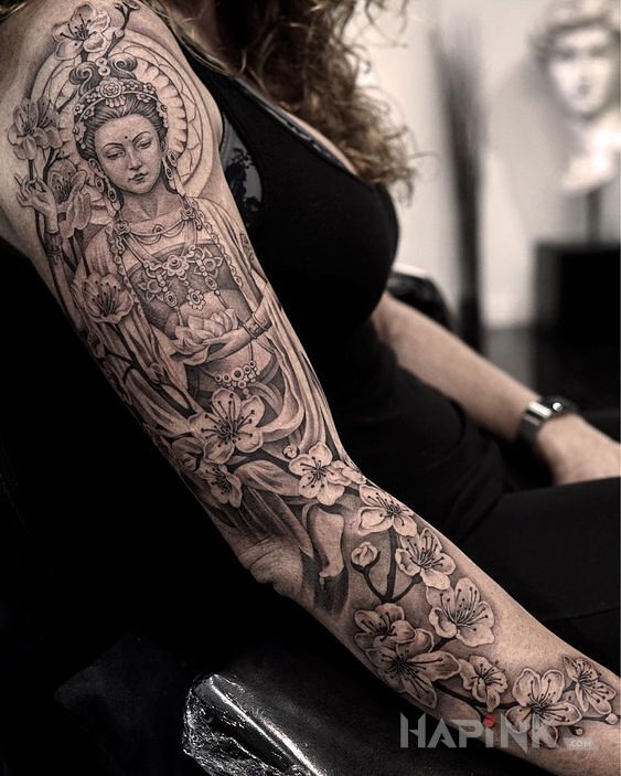 Tattoo Hinduska bogini in black and gray motif and realistic style on the upper arm