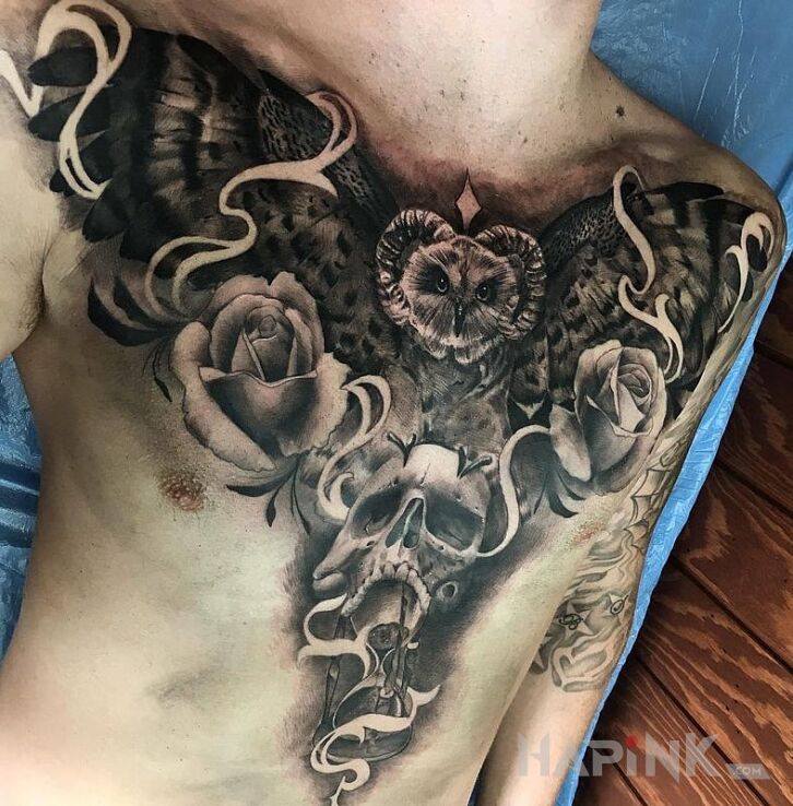 Tattoo Rogata sowa in flowers motif on the stomach