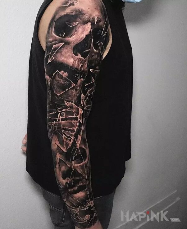 Tattoo Czaszka i fragmenty szkła in faces motif and realistic style on the forearm
