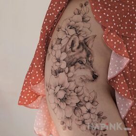 Tattoo Little wolf on the thigh motif: black and gray style: realistic