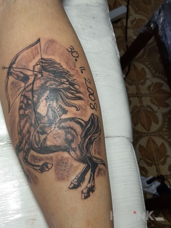 Tattoo Strzelec in black and gray motif and graphic / illustrative style on the calf