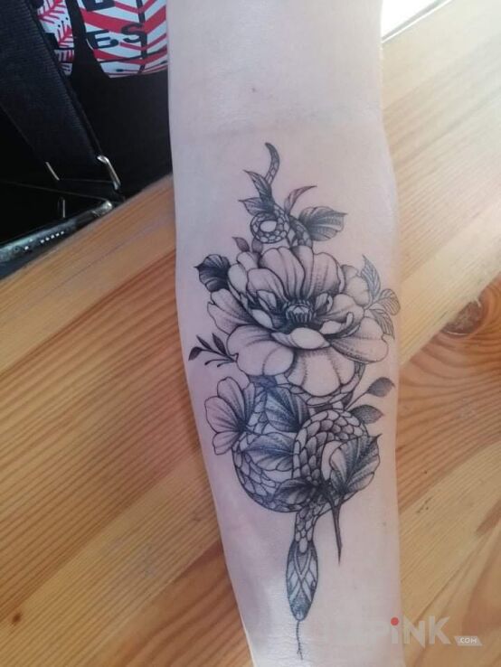 Tattoo Mój nowy in flowers motif and graphic / illustrative style On the arm