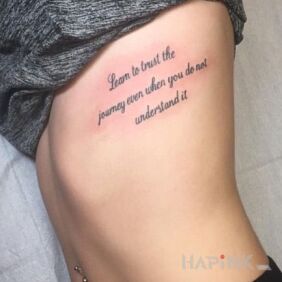 Tattoo Learn to trust on the ribs motif: lettering style: calligraphy
