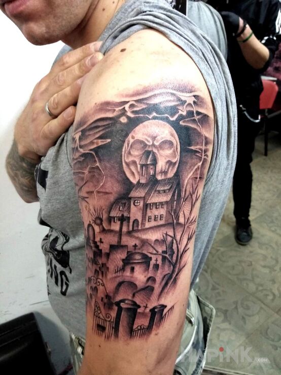 Tattoo Cmentarz in dark motif and graphic / illustrative style on the upper arm