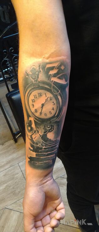 Tattoo Pamiątka narodzin córeczki. in black and gray motif and modern / cubism style on the forearm