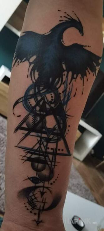 Tattoo Feniks in fantasy motif and geometric style on the forearm