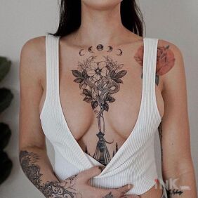 Tattoo Snake emerging from flowers on the chest motif: flowers style: graphic / illustrative