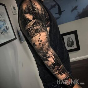 Tattoo House in the forest on the upper arm motif: black and gray style: realistic