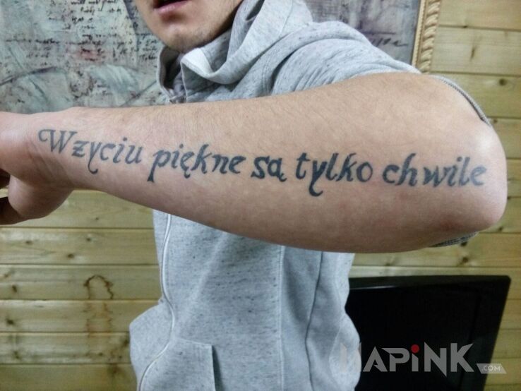 Tattoo W zyciu piekne sa tylko chwile in lettering motif on the forearm