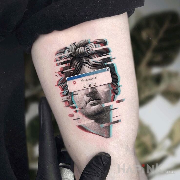 Tattoo Disconected in faces motif and realistic style on the bicep