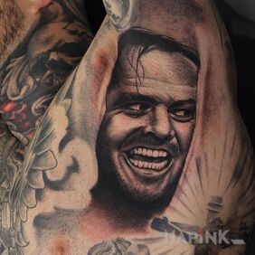 Tattoo Jack nicholson on the neck motif: black and gray style: realistic