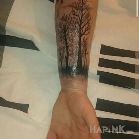 Tattoo Dark forest on the forearm motif: nature style: blackwork / blackout