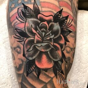 Tattoo Black rose on the upper arm motif: flowers style: blast over