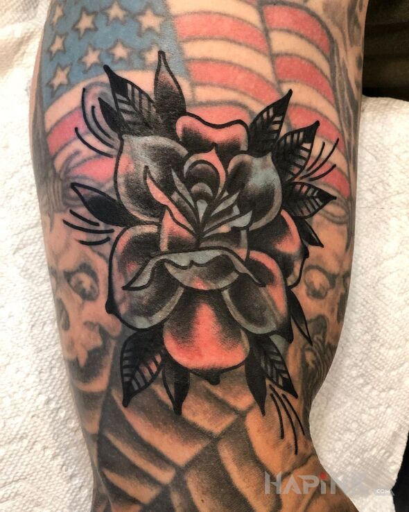 Tattoo Czarna róża in flowers motif and blast over style on the upper arm