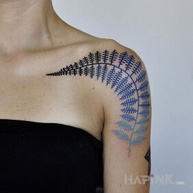 Tattoo Blue leaf on the upper arm motif: floral style: graphic / illustrative