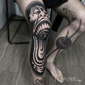Tattoo Smashed face on the leg motif: black and gray style: graphic / illustrative