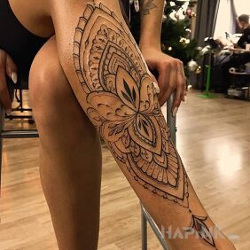 Tattoo Leg in a lotus flower on the leg motif: ornaments style: contour / linework