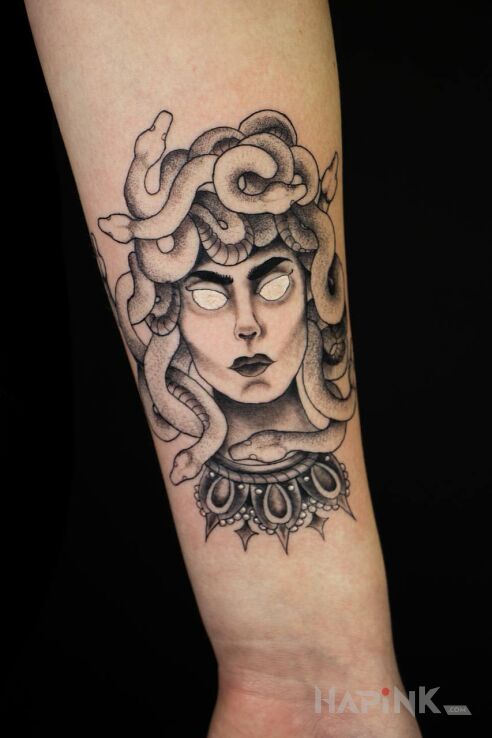 Tattoo Medusa in black and gray motif and graphic / illustrative style On the arm