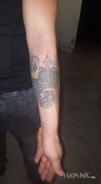 Tattoo Korona diament in objects motif and realistic style On the arm