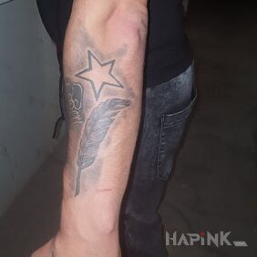 Tattoo Feather star On the arm motif: black and gray style: realistic