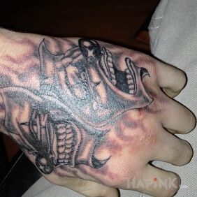 Tattoo 2 masks on the hand motif: faces