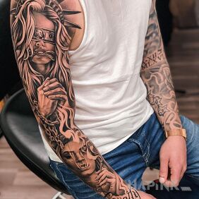 Tattoo Statue of Liberty no longer so free On the arm motif: sleeves style: realistic