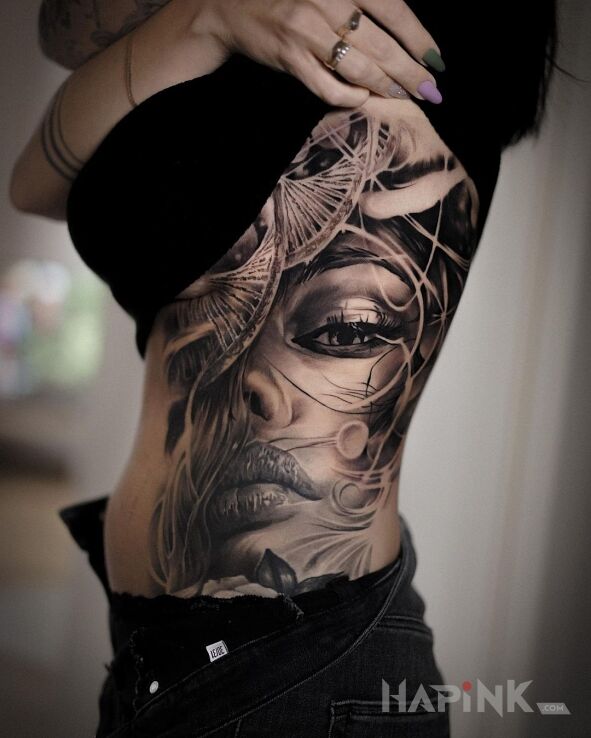 Tattoo Buzia DNA in faces motif and realistic style on the ribs