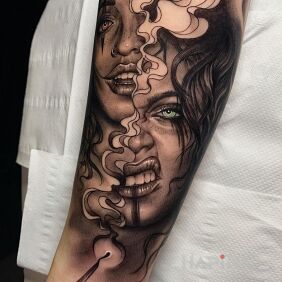 Tattoo Two Faces On the arm motif: faces style: realistic