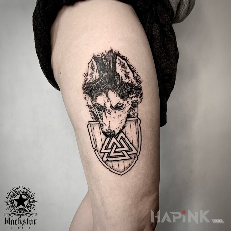 Tattoo Wilk. in black and gray motif and graphic / illustrative style on the thigh