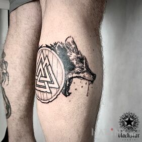 Tattoo Wolf. on the calf motif: black and gray style: graphic / illustrative