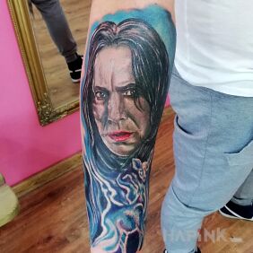 Tattoo Snape On the arm motif: faces style: realistic