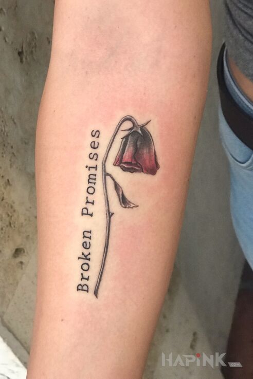 Tattoo Złamane obietnice in lettering motif and graphic / illustrative style on the forearm