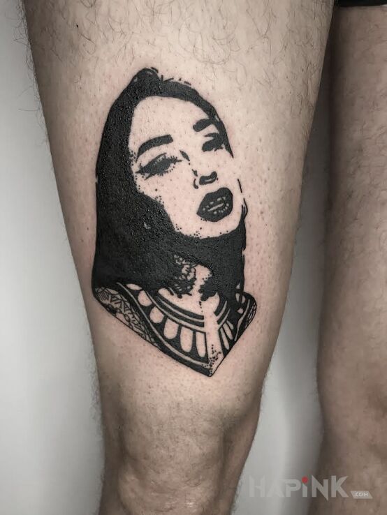 Tattoo Twarz in faces motif and blackwork / blackout style on the thigh