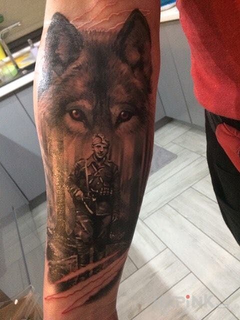 Tattoo Żołnierze wyklęci "Tarzan" in patriotic motif on the forearm