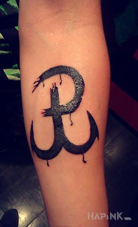 Tattoo P in patriotic motif on the forearm