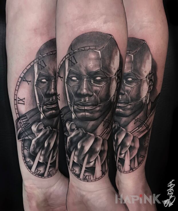 Tattoo Mortal in faces motif and realistic style On the arm