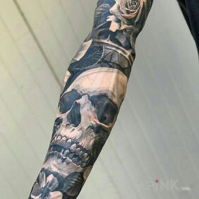 Tattoo Skull arranged in flowers on the forearm motif: skulls style: realistic