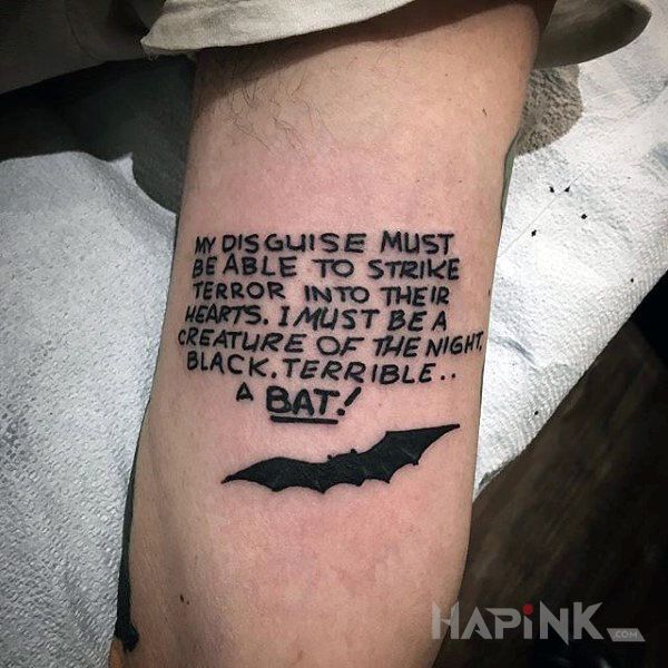 Tattoo Opis batmana in lettering motif On the arm