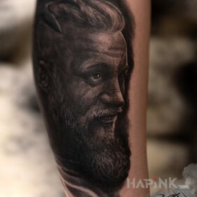 Tattoo Ragnar on the forearm motif: black and gray style: realistic