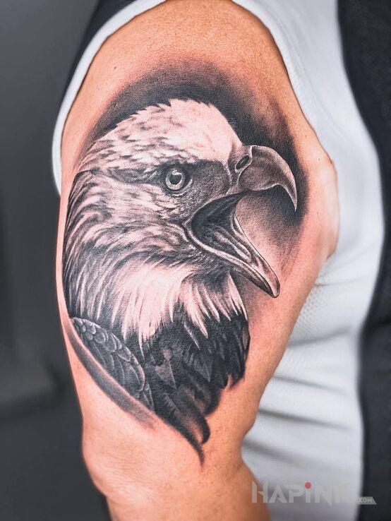 Tattoo Eagle tattoo in black and gray motif and realistic style on the upper arm