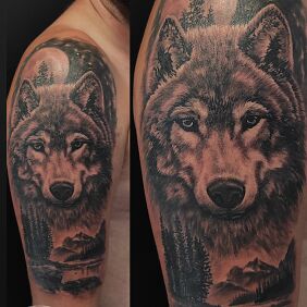Tattoo Mountain wolf landscape on the upper arm motif: black and gray style: realistic
