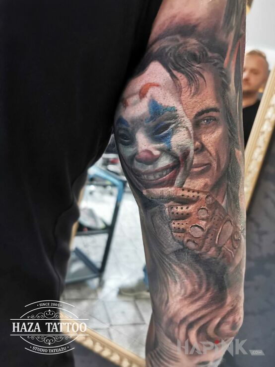 Tattoo Clown mask man in sleeves motif and realistic style On the arm