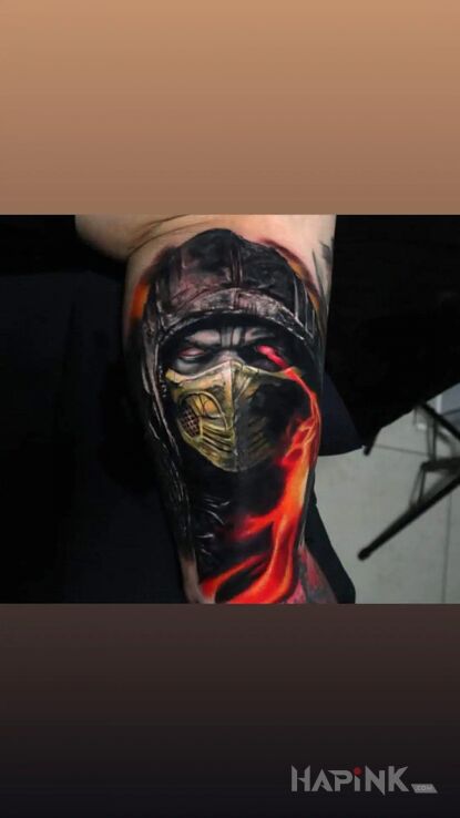 Tattoo Mortal kombat skorpion in characters motif and realistic style on the bicep