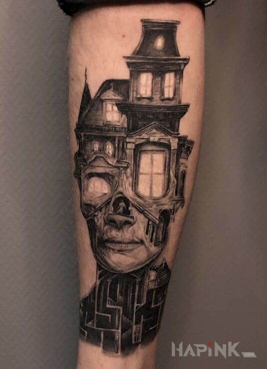 Tattoo Twarz in black and gray motif and surrealistic style on the calf
