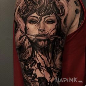 Tattoo Woman on the upper arm motif: black and gray style: realistic