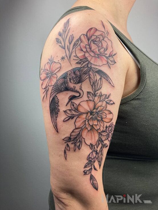 Tattoo Flowers and bird in floral motif and contour / linework style on the upper arm