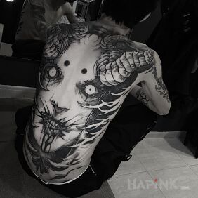 Tattoo Horned spawn from hell on the shoulder blades motif: black and gray style: realistic
