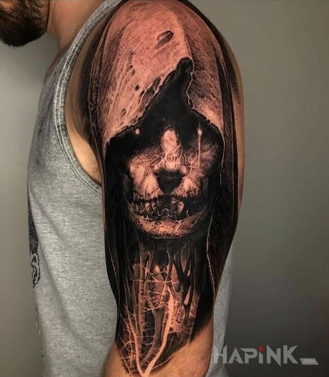 Tattoo Postać w kapturze in black and gray motif and realistic style on the upper arm